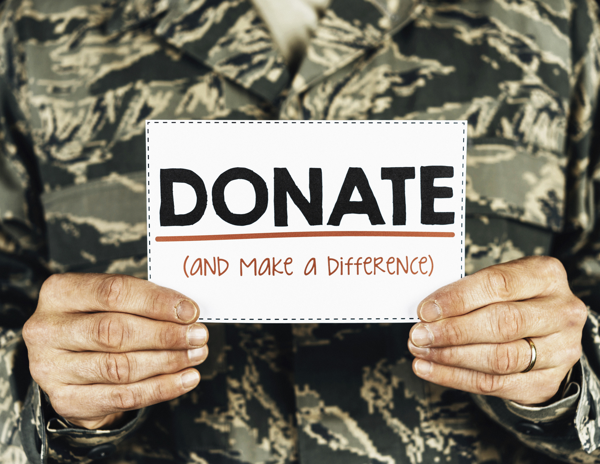 Military service member with donate sign